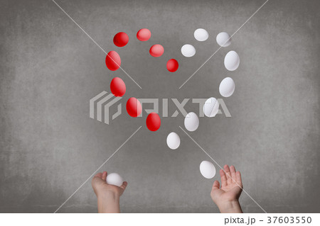 Female hands juggle eggs in the form of Valentine 37603550
