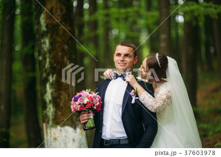 The newlyweds are walking in the park on the 37603978