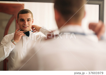 The groom is dressed at home in a suit. Cute groom 37603979