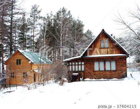 Old rustic wooden house in the snowy forest  37604215