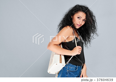Sexy girl with black curly hair carrying white Sexy girl with black curly hair carrying white 37604639