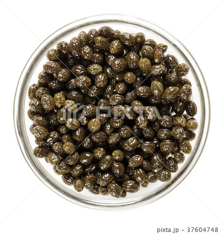 Fresh black papaya seeds in glass bowl over white 37604748