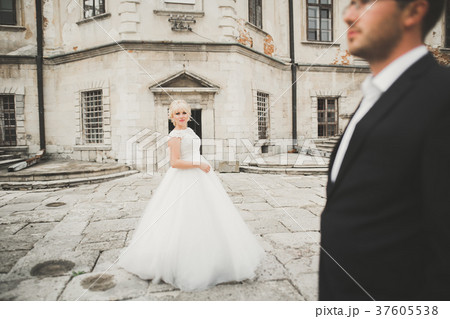 Beautiful fairytale newlywed couple hugging near 37605538