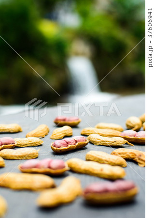 Opened peanuts on the rock in the nature 37606941