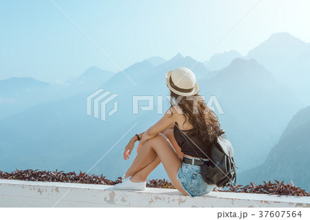 Beautiful young tourist girl with backpack at 37607564