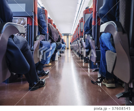 People sit in Train Japanese Passenger seats row  37608545
