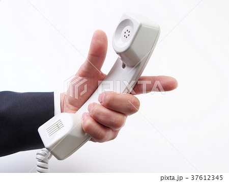 受話器を持って指差しをするビジネスマンの写真素材