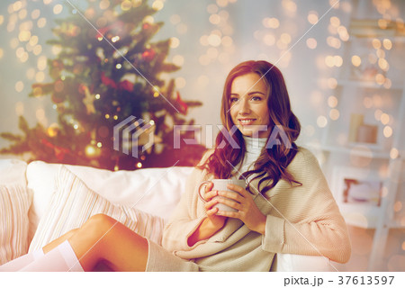 happy woman with cup of tea at home for christmas happy woman with cup of tea at home for christmas 37613597