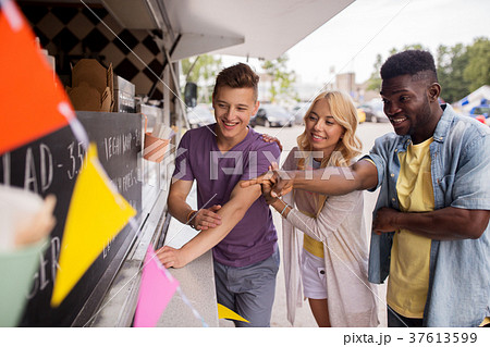 customers or friends choosing menu at food truck customers or friends choosing menu at food truck 37613599