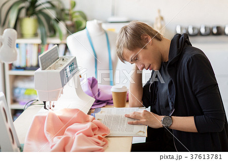 fashion designer reading book at studio 37613781