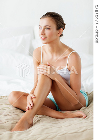 beautiful woman with bare legs on bed at home 37613871