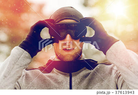 sports man with ski goggles in winter outdoors 37613943