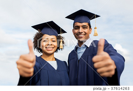 happy students or bachelors showing thumbs up 37614263