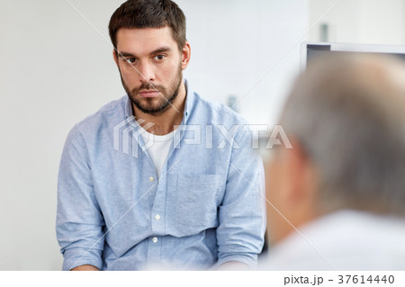 young male patient talking to doctor at hospital 37614440