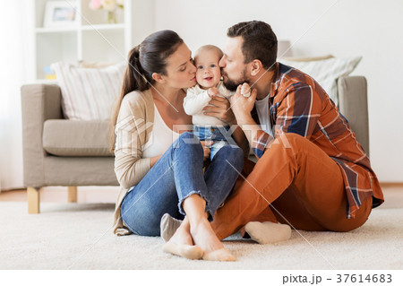 happy mother and father kissing baby at home happy mother and father kissing baby at home 37614683