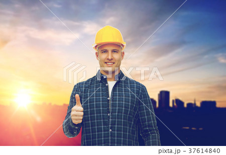 male builder in yellow hard hat showing thumbs up 37614840