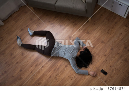 dead woman body lying on floor at crime scene 37614874