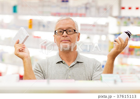senior male customer choosing drugs at pharmacy 37615113
