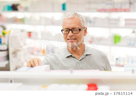 senior male customer with drug at pharmacy 37615114