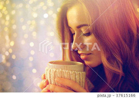 close up of happy woman with tea or coffee cup 37615166