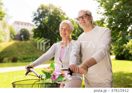 happy senior couple with bicycles at summer park 37615912
