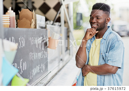 male customer looking at billboard at food truck male customer looking at billboard at food truck 37615972