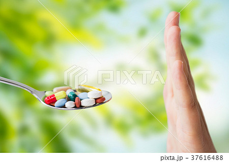 hand of woman refusing from pills on spoon 37616488