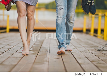 Bare male and female feet are on the footbridge Bare male and female feet are on the footbridge 37621810