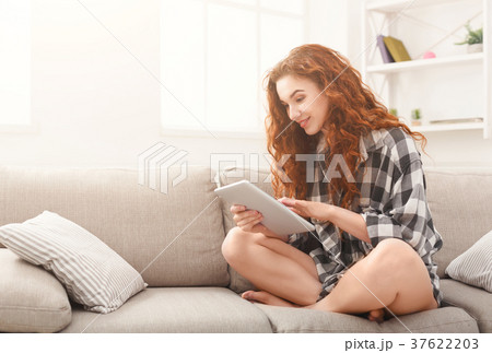 Happy girl with digital tablet at home Happy girl with digital tablet at home 37622203
