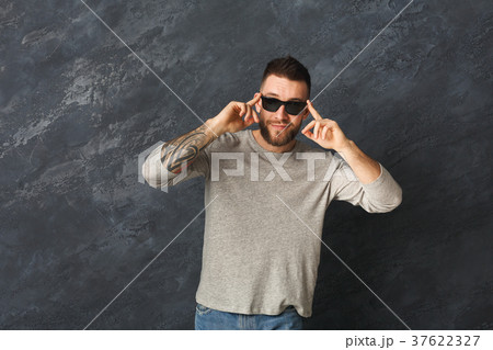 Handsome smiling man posing in studio Handsome smiling man posing in studio 37622327