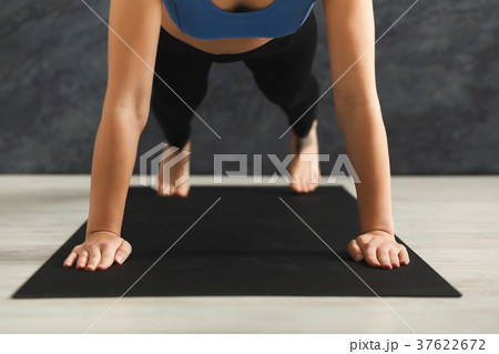 Unrecognizable woman training yoga in plank pose Unrecognizable woman training yoga in plank pose 37622672