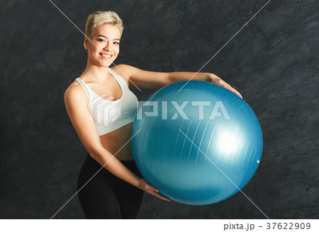 Fitness woman training with fitness ball indoors 37622909