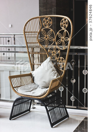 Braided brown chair on black legs with high back 37624846