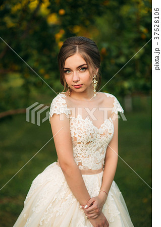 Young girl in wedding dress in park posing for Young girl in wedding dress in park posing for 37628106