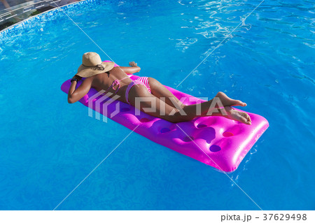 Young slim woman straw hat gets suntan 37629498