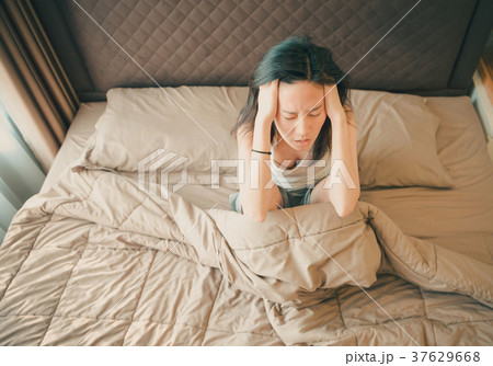 Asian woman suffering from depression on bed Asian woman suffering from depression on bed 37629668