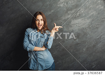 Young happy woman point away Young happy woman point away 37636587