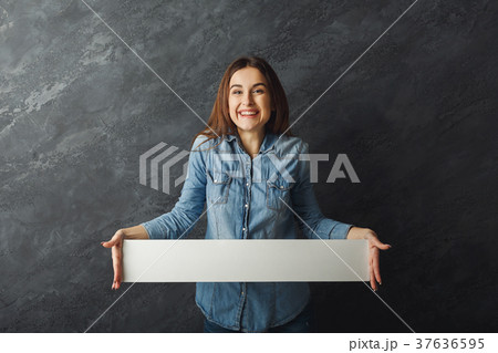 Young woman holding blank white banner Young woman holding blank white banner 37636595