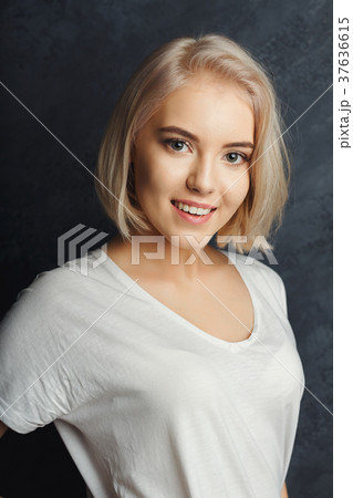Young woman studio headshot portrait on dark 37636615