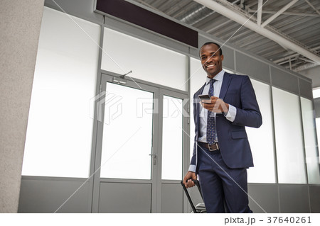 Positive stylish african man is surfing internet Positive stylish african man is surfing internet 37640261