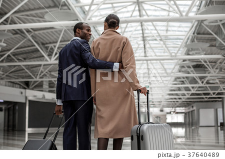 Male and female are standing with baggage 37640489