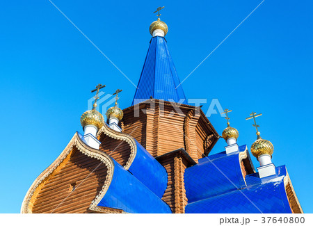 Traditional wooden orthodox church with domes Traditional wooden orthodox church with domes 37640800