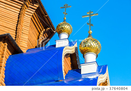 Golden domes with crosses on wooden Golden domes with crosses on wooden 37640804