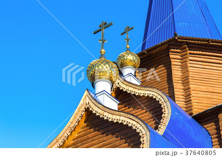 Golden domes with crosses on wooden church 37640805