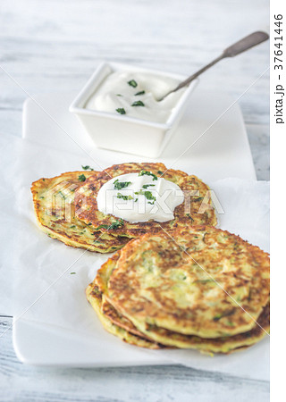 Portion of zucchini fritters with greek yogurt 37641446
