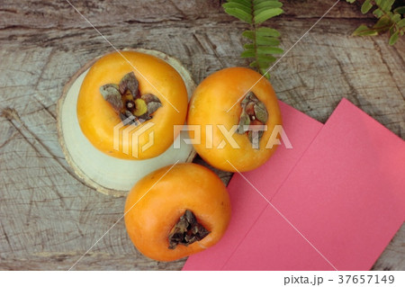 persimmons fruit with red envelopes 37657149