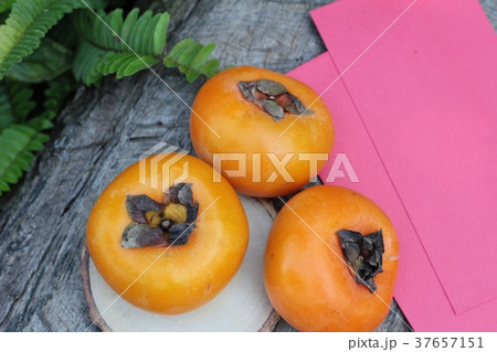 persimmons fruit with red envelopes 37657151