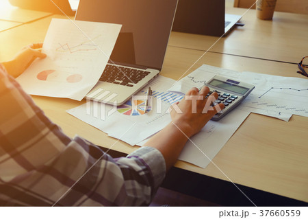Asian Business woman using a calculator 37660559