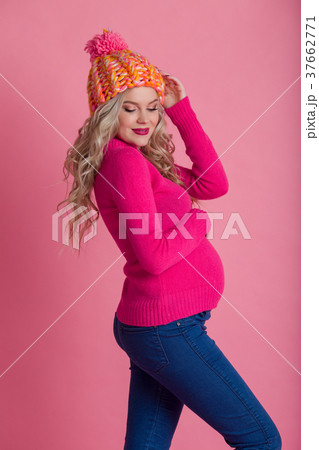 Blonde pregnant woman is wearing warm winter 37662771