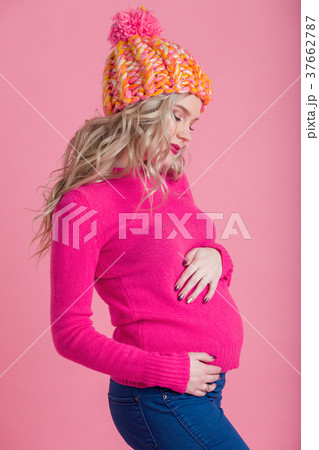 Blonde happy pregnant woman is wearing warm winter Blonde happy pregnant woman is wearing warm winter 37662787